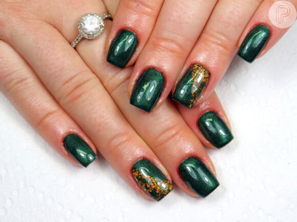 Nail art com fundo verde escuro: que tal essa versão com detalhes dourados?