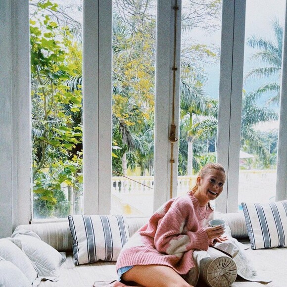 Marina Ruy Barbosa aposta no estilo cowgirl e usa um look composto por altas botas rosas, short jeans e suéter rosa com estampas brancas