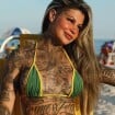 Quem é a 'mulher mais tatuada do Brasil'? Vídeo de influenciadora em biquíni fio-dental na praia viraliza e causa polêmica: 'Lama no corpo'