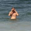 Pedro Bial percebe que está sendo fotógrafado em dia de praia no Rio