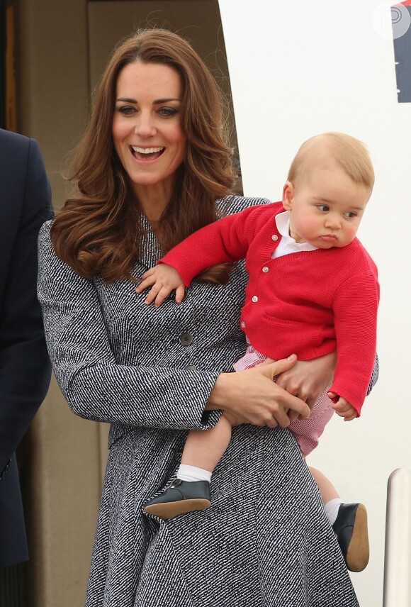 Aos 10 meses de vida, o príncipe George já mostrava estilo no colo da mãe, Kate Middleton, com um cardigan vermelho