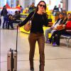 Mariana Ximenes apostou em calça de couro na cor caramelo e botas de salto para embarcar em aeroporto