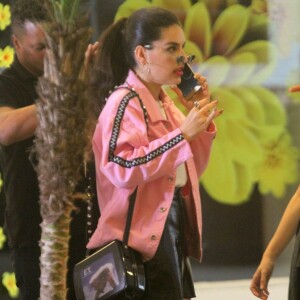 Kéfera usou jaqueta rosa, minissaia, botas pretas, óculos, batom vermelho e rabo-de-cavalo