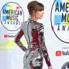 A combinação de vestido curto metalizado e bota over knee com o mesmo efeito foi a escolha de Taylor Swift para o AMA 2018