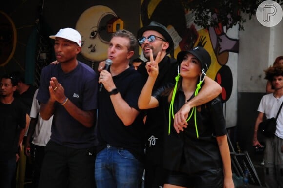 Anitta foi à comunidade carioca com Pharrell Williams e Luciano Huck