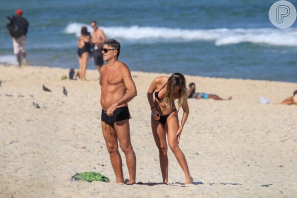 Carol Portaluppi passa bronzeador solar em dia na praia com o pai, Renato Gaúcho