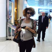 Taís Araújo embarca sozinha em aeroporto e exibe barriga de grávida