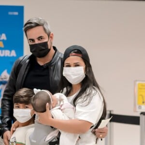 De boné, Simone posa com os filhos, Henry e Zaya, e o marido, Kaká Diniz, em aeroporto