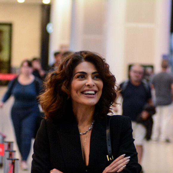 Juliana Paes usa conjuntinho all black composto por top, saia longa e blazer preto ao desembarcar em aeroporto
