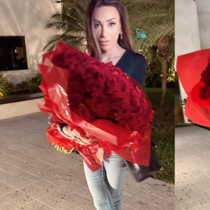 Maya Massafera aparece com um look estiloso e segurando um buquê de flores vermelhas. "Obrigada", disse
