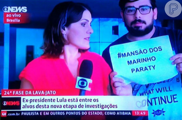 Homem invade a transmissão da Globo News e mostra cartaz contra a TV Globo