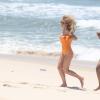Fiorella Mattheis corre na praia da Reserva no Rio durante gravação de comercial