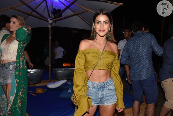 Camila Coelho combinou short jeans com camisa cropped ombro a ombro para a festa Corona Sunset em Fernando de Noronha, em 28 de dezembro de 2017