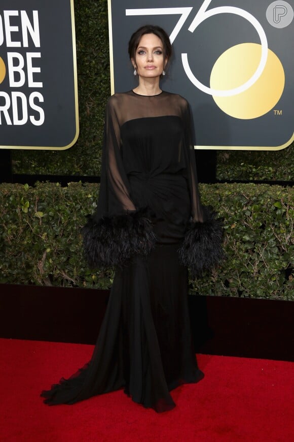 Angelina Jolie surgiu deslumbrante ao desfilar sobre o tapete vermelho com vestido preto Atelier Versace 