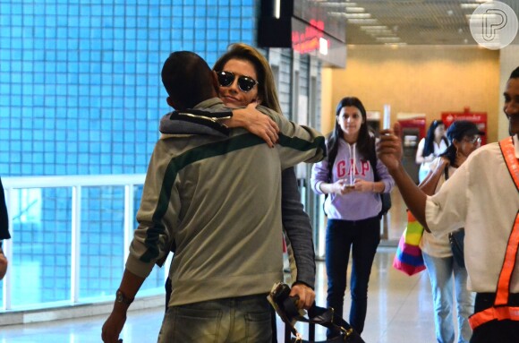 Deborah Secco dá abraço carinhoso em amigo no aeroporto