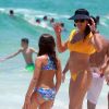 Flávia Alessandra e a filha Olívia escolheram biquínis com tons vibrantes para o dia de praia