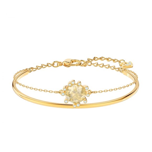 O bracele dourado da Swarowski (R$ 549) combina com...