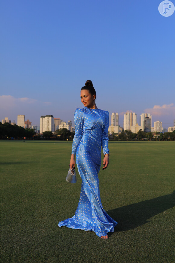 O vestido longo azul de poá usado por Flávia Pavanelli no noivado de Mari Saad é da estilista Alessandra Rich