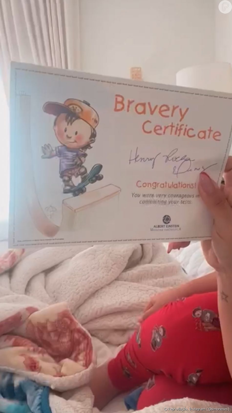 Simone exibiu o 'Certificado de Bravura' conquistado pelo filho, Henry, que aguentou firme as agulhadas