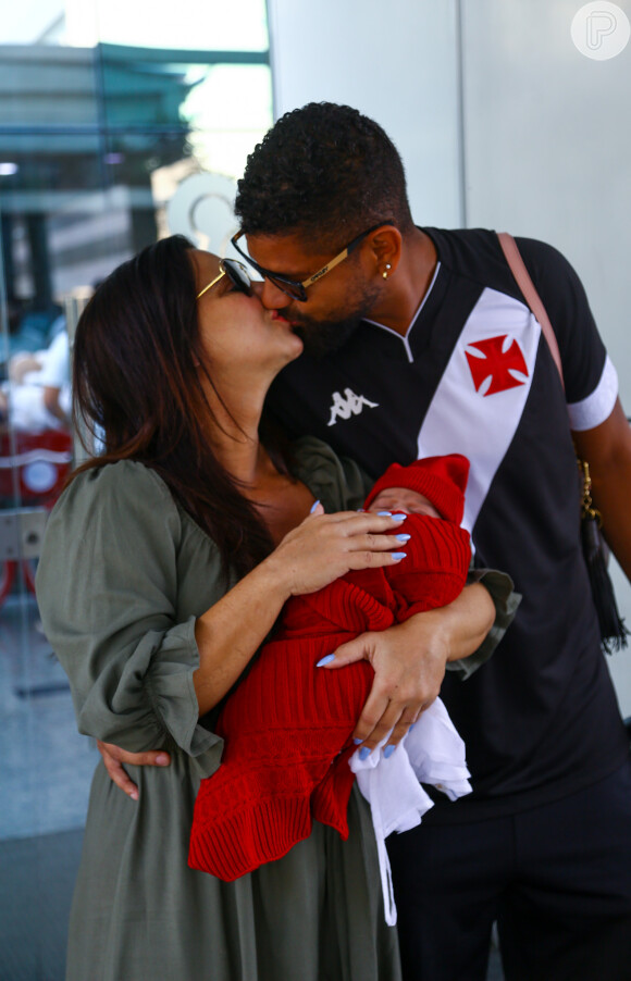 Com Joaquim nos braços, Viviane Araujo beija o marido, Guilherme Militão