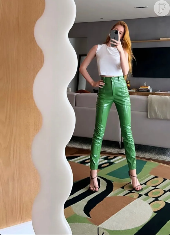 Marina Ruy Barbosa faz selfie no espelho combinando t -shirt branca com calça de vinil verde