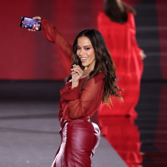 Anitta faz selfie durante desfile de moda