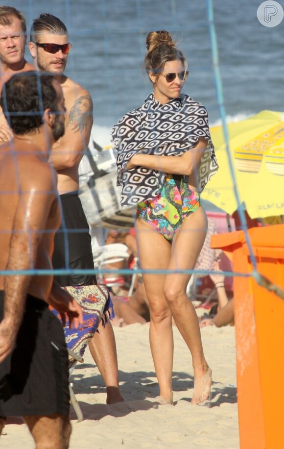 Fernanda Lima se cobre com canga na praia do Leblon, no Rio