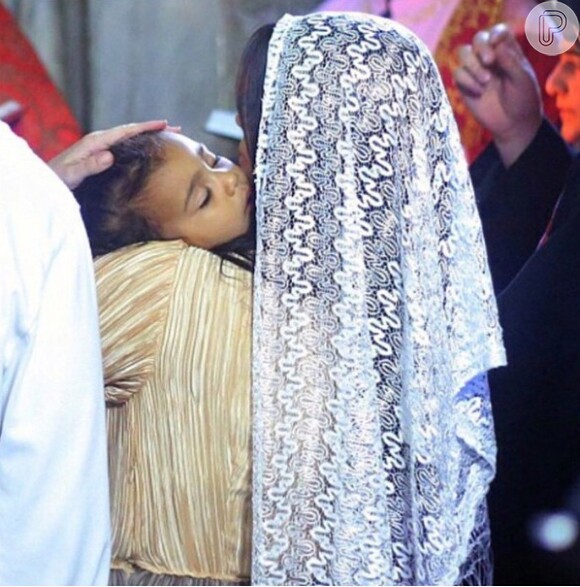 Kim Kardashian usou um véu e segurou a pequena North West no colo durante o batizado