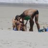 Felipe Titto beija a mulher, Mel Martinez em praia do Rio