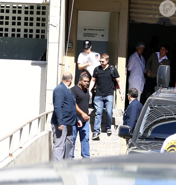 Demi Lovato deixa hotel cercada por seguranças
