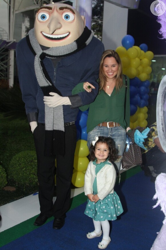 Mariana Belém posa com a filha, Laura, ao lado dos personagens que recepcionavam os convidados na entrada da festa de aniversário de Pietro Mesquita