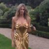 Fernanda Lima passeia pelo jardim do Maison de L'Amérique Latine com look dourado