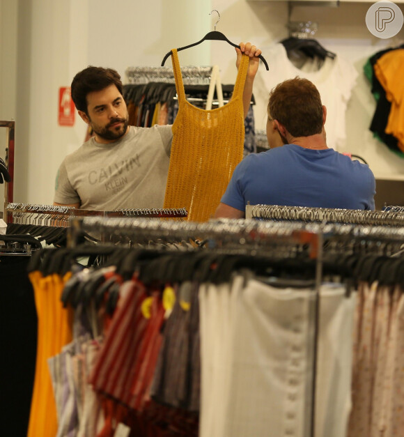 O português Pedro Carvalho ajuda Glamour Garcia a escolher peça de roupa em dia de compras