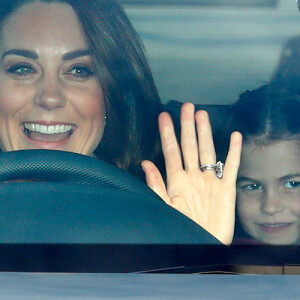 Kate Middleton acena para fotos ao chegar em almoço de família real no carro com os filhos