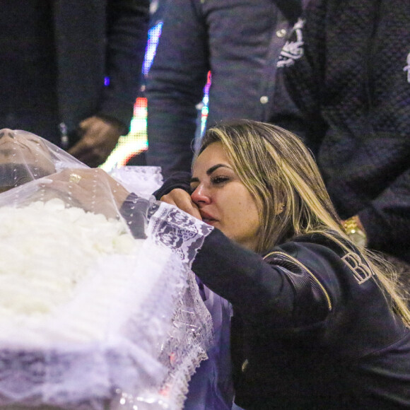 Viúva chora sobre caixão de MC Kevin em velório realizado na escola de samba Unidos de Vila Maria, no bairro Parque Novo Mundo, na zona norte de São Paulo, nesta segunda-feira, 18 de maio de 2021