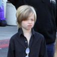 Shiloh desfila de chinelo, bermudão e camisa de botão aos 6 anos