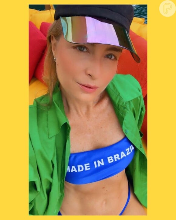Angélica aposta no top de biquíni reto com a expressão: 'Made in Brazil' e exibiu barriga chapada