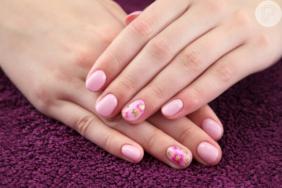 Esmalte rosa delicado faz uma combinação perfeita com nail art floral