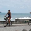 Débora Nascimento e José Loreto pedalam na orla da Praia da Macumba, no Rio de Janeiro
