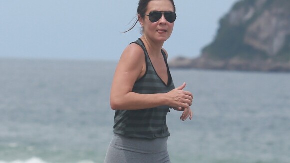 Adriana Esteves, da novela 'Babilônia', usa camiseta regata ao correr em praia