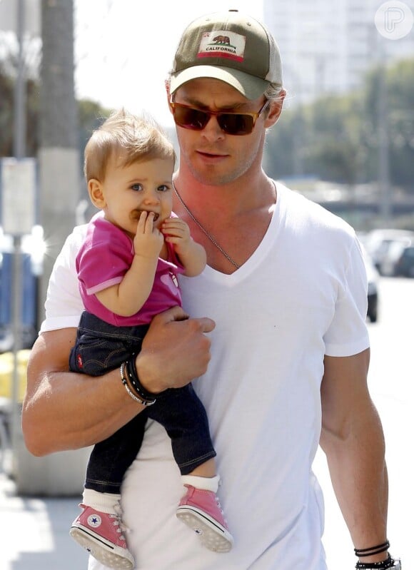 Chris Hemsworth passeia com India Rose Hemsworth no colo e mostra que a menina, de 1 ano, tem estilo: de calça jeans e camisa cor de rosa combinando com o tênis All Star versão mini