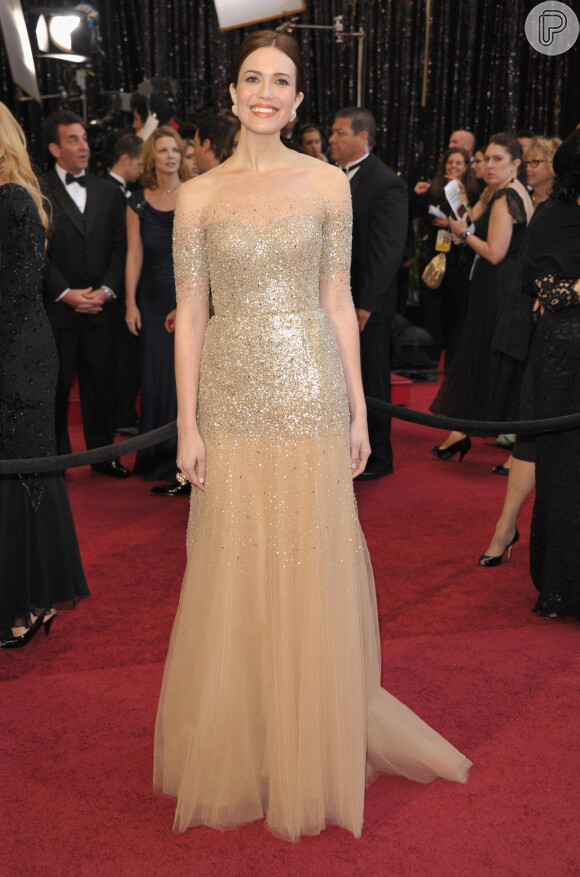 Mandy Moore usa longo nude com cristais da grife Monique Lhuillier no Oscar 2011. Com os cabelos presos, o brilho do modelo deixou a atriz relusente