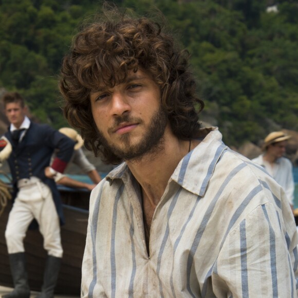 Baleado, Joaquim (Chay Suede) é resgatado por índios e levado para uma aldeia, enquanto Anna (Isabelle Drummond) se desespera achando que ele está morto, na novela 'Novo Mundo', a partir de 28 de março de 2017