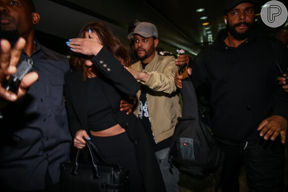 Selena Gomez colocou a mão no rosto para escapar dos flashes dos paparazzi