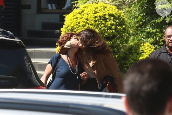 Maria Casadevall coloca a mão no rosto de Marília Carneiro e finge dar beijo