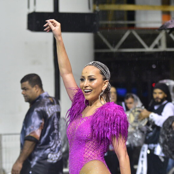 Sabrina Sato usou um maiô rosa com volume nas mangas e não se incomodou com a chuva