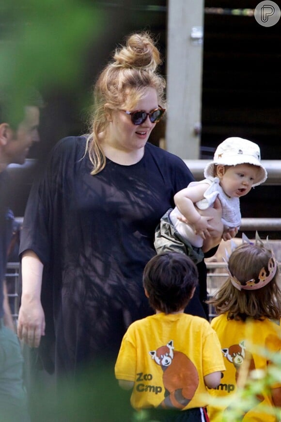 Adele segura o filho, Angelo, perto de outras crianças que se divertem no zoológico de Nova York