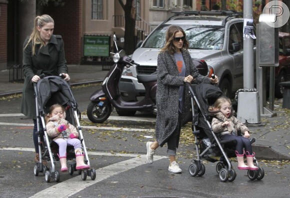 Sarah Jessica Parker levando suas filhas, em um dia frio e nublado, para a escola em Nova Iorque