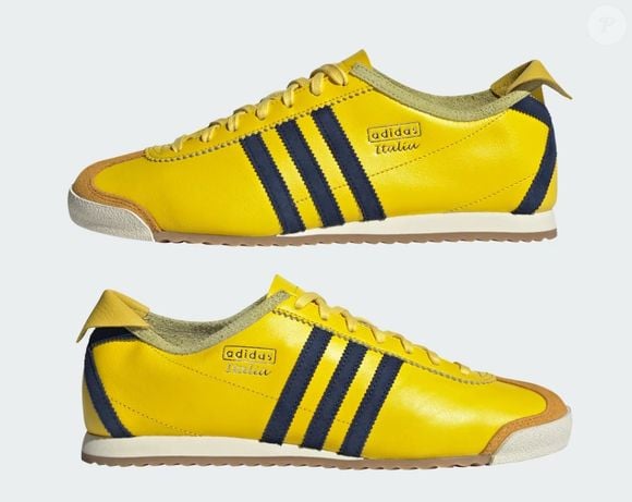 Apesar da cor chamativa, o visual é equilibrado pelos detalhes em azul-marinho nas icônicas três listras da Adidas e no calcanhar