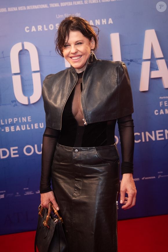Bárbara Paz apostou em um look all black, combinando jaqueta cropped de couro, blusa de transparência sutil e saia de efeito envernizado